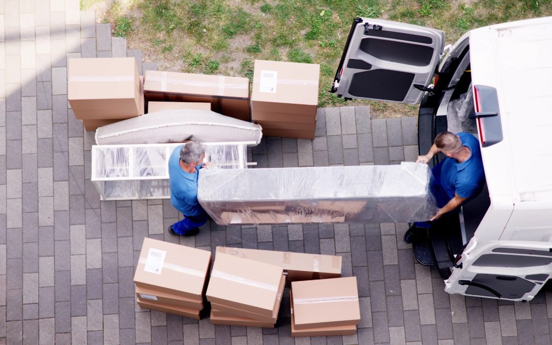 Movers handling large furniture in a North Georgia mountain home